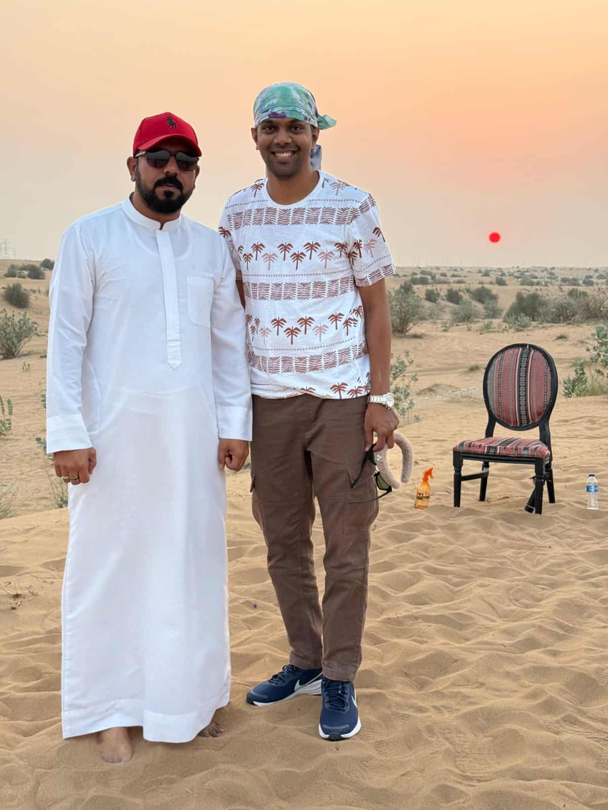 Professional desert safari guides Jahangir with Guest posing in the Dubai desert.